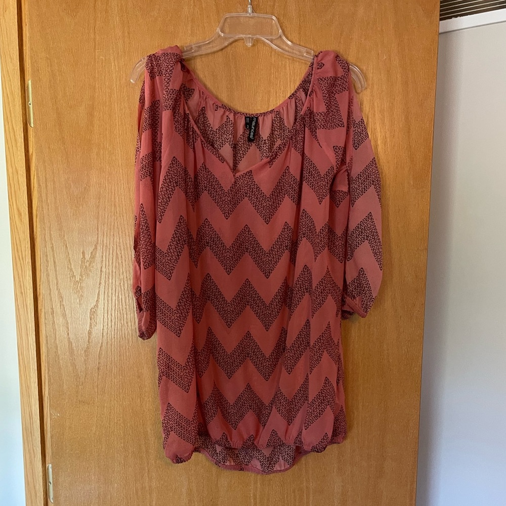 Coral and black blouse with peep hole sleeves.